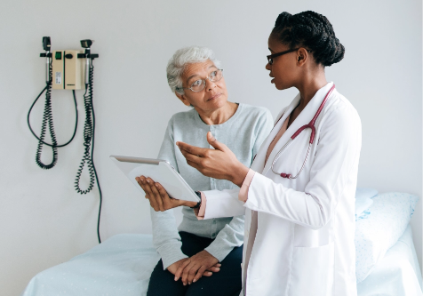 Female doctor explaining information to senior patient.